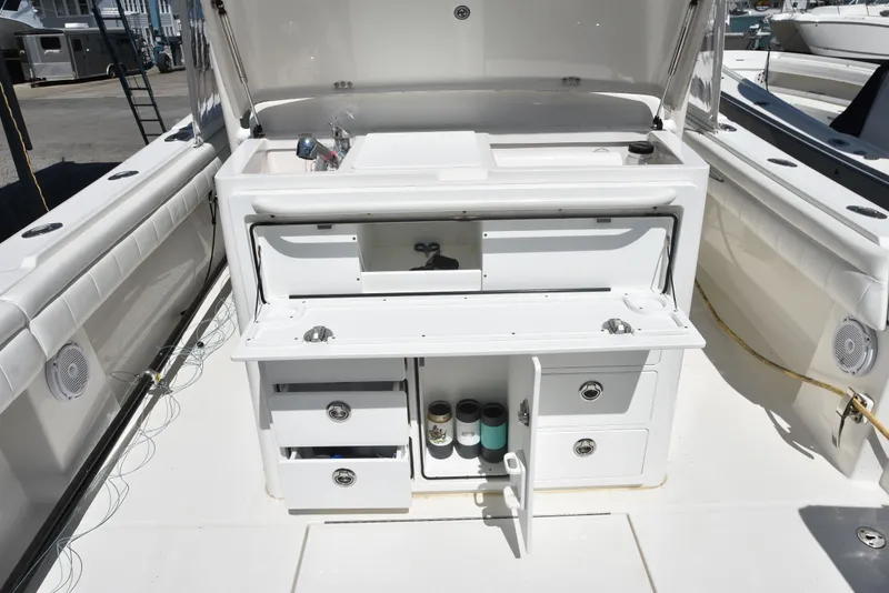 Slide: The Image of 2018 Regulator 34SS with open storage compartment and drawers. - 14