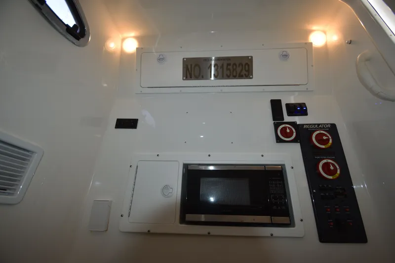 Slide: The Image of Interior of 2018 Regulator 34SS boat with controls and microwave. - 23