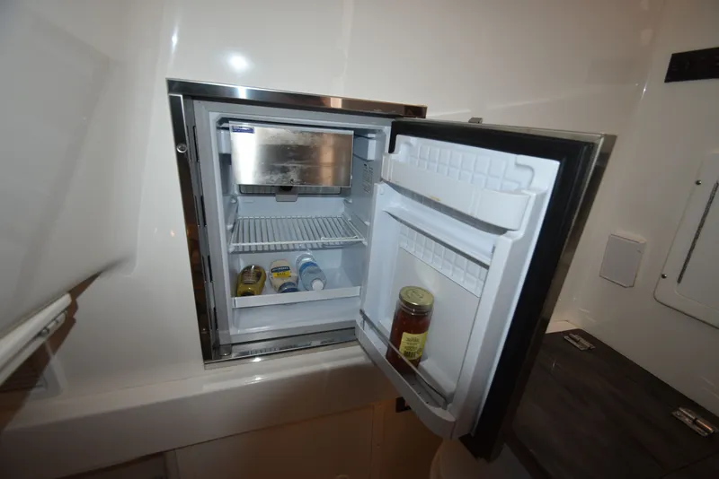 Slide: The Image of Open refrigerator on a 2018 Regulator 34SS boat. - 28