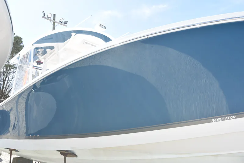 Slide: The Image of 2018 Regulator 34SS boat with blue hull, side view. - 29