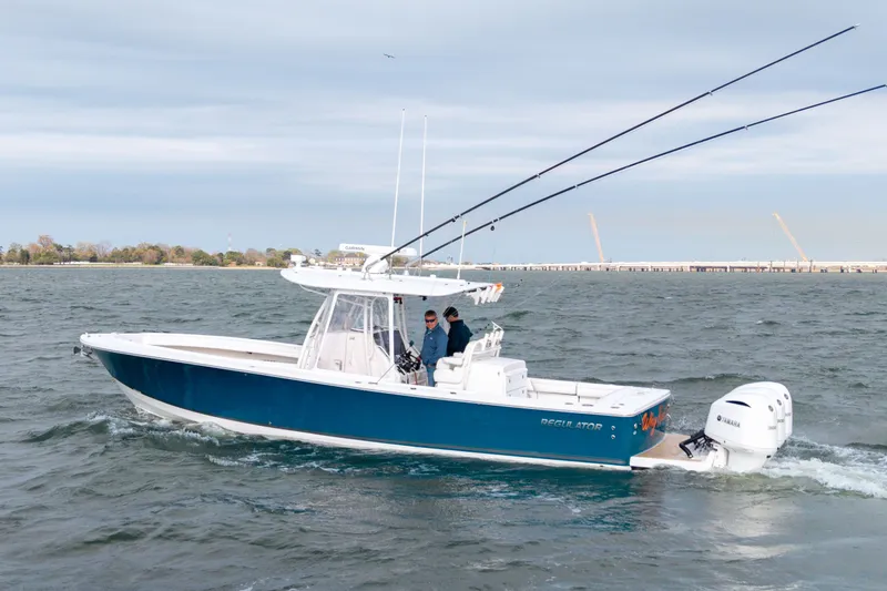 Slide: The Image of 2018 Regulator 34SS boat on water with dual outboard engines. - 38