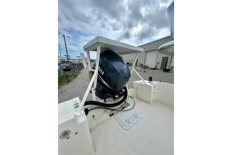 Slide: The Image of 1984 Hydra-Sports 1800 CC boat with Yamaha outboard motor, parked outdoors. - 10