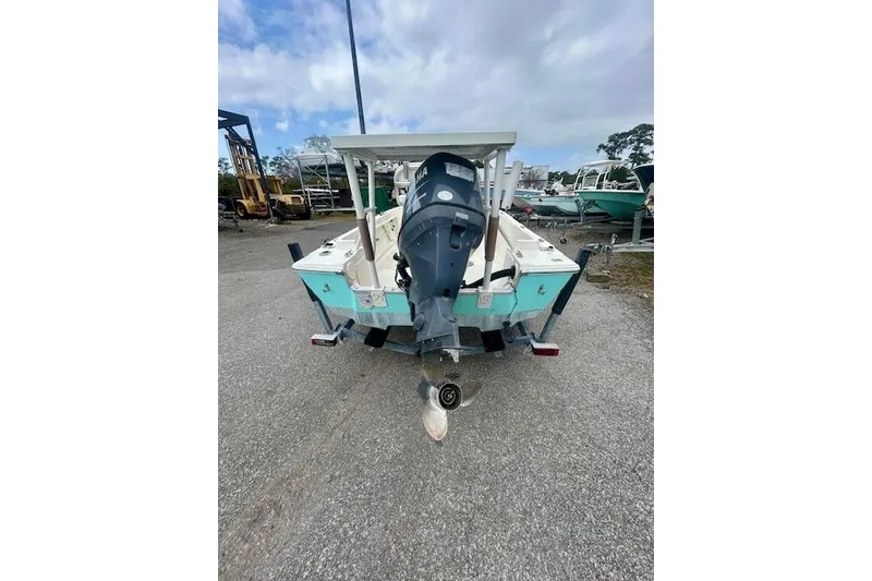 Slide: The Image of 1984 Hydra-Sports 1800 CC boat with outboard motor, parked on a trailer. - 2