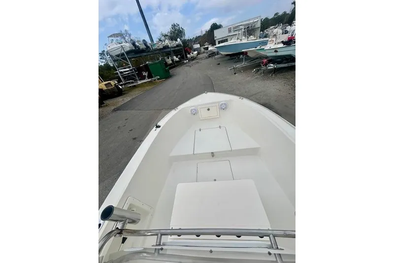 Slide: The Image of 1984 Hydra-Sports 1800 CC boat, docked in a marina with other vessels. - 5