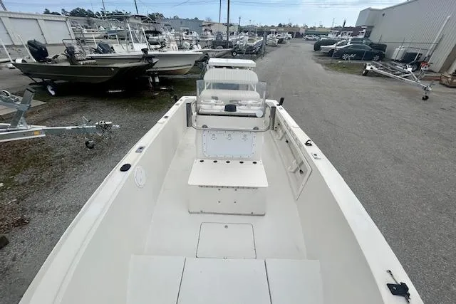 Slide: The Image of 1984 Hydra-Sports 1800 CC boat in a marina, surrounded by other vessels and trailers. - 6