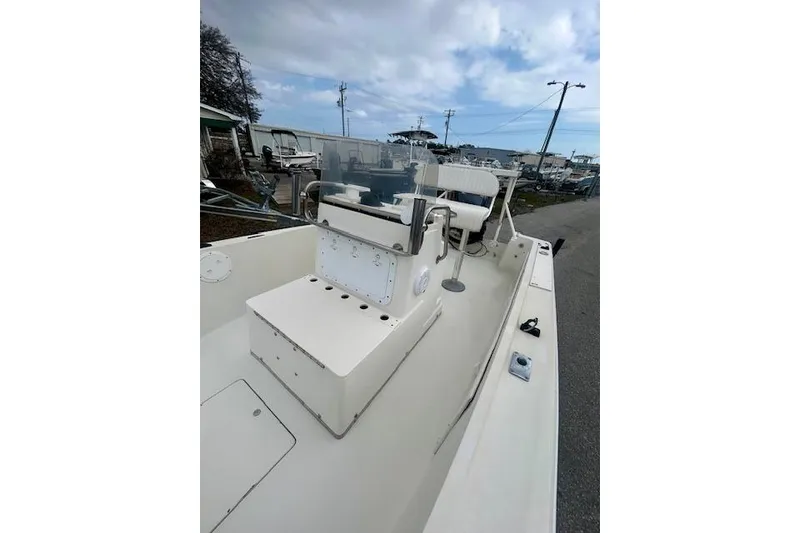 Slide: The Image of 1984 Hydra-Sports 1800 CC boat with center console, docked under cloudy skies. - 7