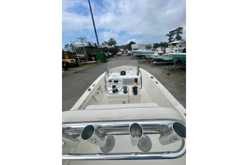 Slide: The Image of 1984 Hydra-Sports 1800 CC boat interior with steering wheel and controls, parked outdoors. - 8