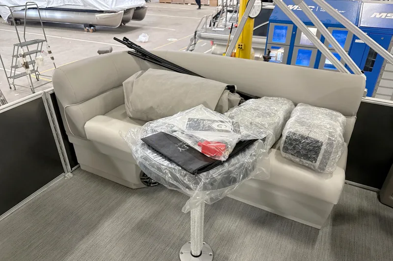 Slide: The Image of 2026 Godfrey EX 2286 SBX pontoon boat interior with wrapped accessories and seating. - 10