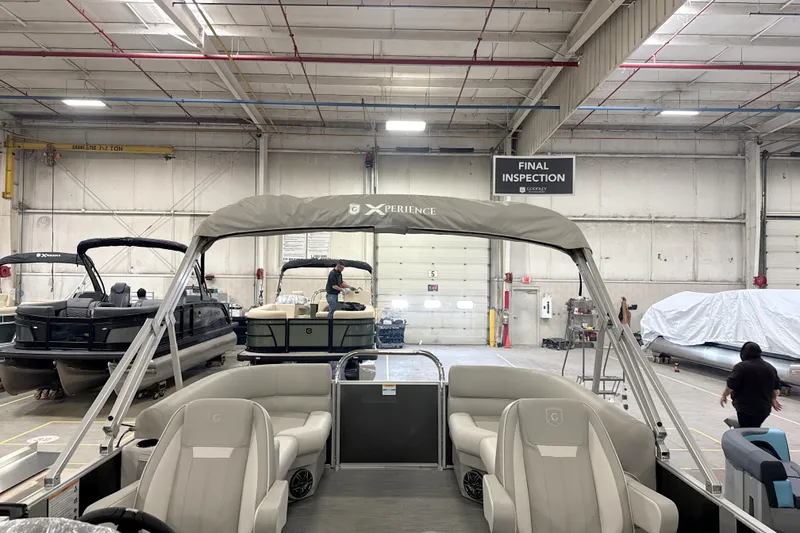 Slide: The Image of 2026 Godfrey EX 2286 SBX pontoon boat in final inspection at manufacturing facility. - 12