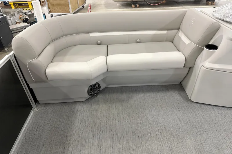 Slide: The Image of Luxurious seating on 2026 Godfrey EX 2286 SBX pontoon boat, featuring plush upholstery and integrated speaker. - 3