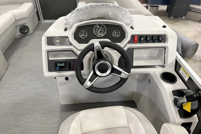 Slide: The Image of 2026 Godfrey EX 2286 SBX boat dashboard with steering wheel and control panel. - 6