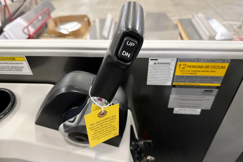 Slide: The Image of Control lever of 2026 Godfrey EX 2286 SBX boat with capacity warning label. - 7