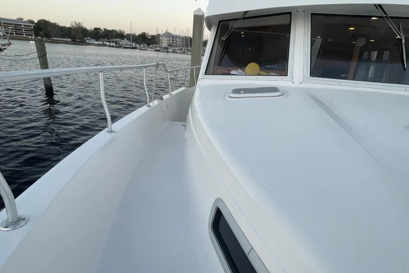 Slide: The Image of 2003 Mainship 430 Trawler deck view, docked by the water. - 10