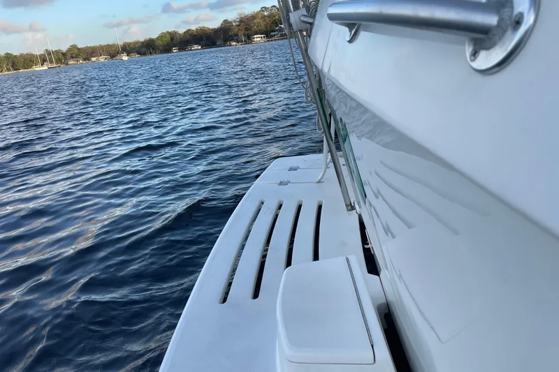 Slide: The Image of 2003 Mainship 430 Trawler on calm water, showcasing sleek design and sturdy construction. - 13