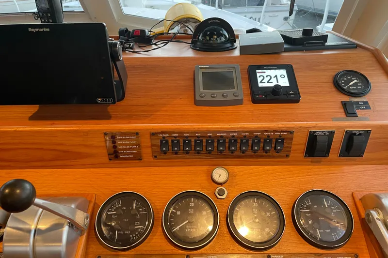 Slide: The Image of Control panel of a 2003 Mainship 430 Trawler with navigation instruments and gauges. - 23