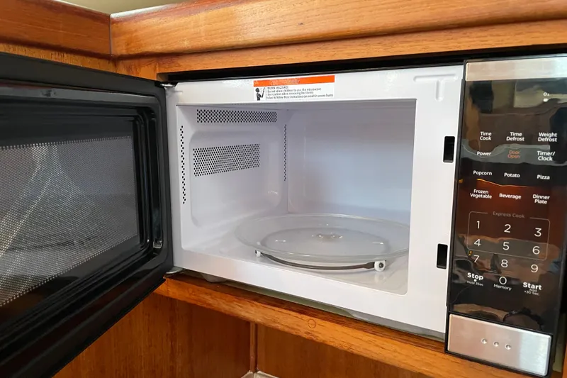 Slide: The Image of Open microwave oven in a 2003 Mainship 430 Trawler kitchen. - 29