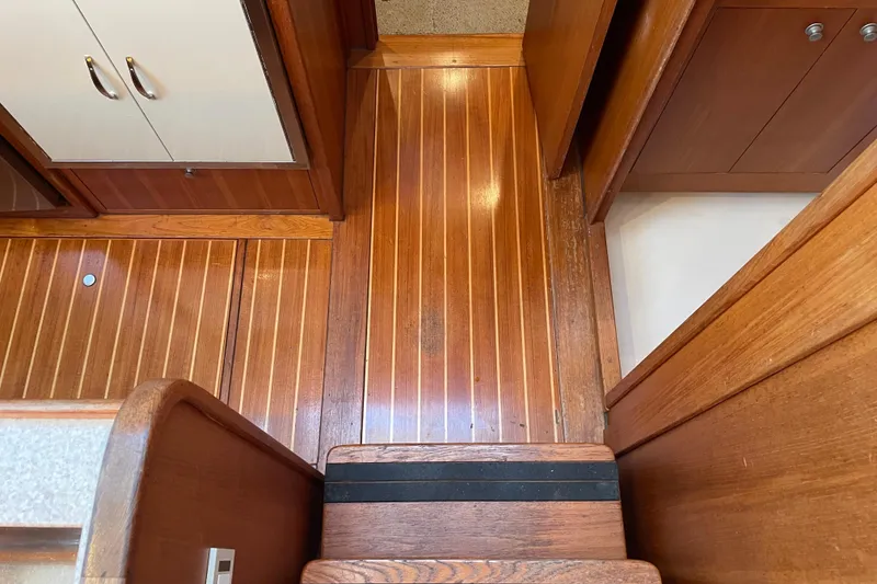 Slide: The Image of Wooden interior flooring and cabinetry of 2003 Mainship 430 Trawler boat. - 30