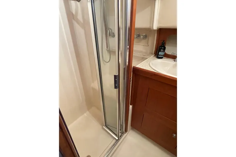 Slide: The Image of 2003 Mainship 430 Trawler bathroom with shower and sink area. - 41