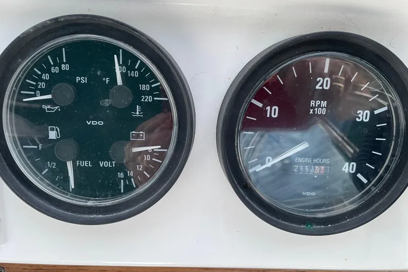 Slide: The Image of Close-up of 2003 Mainship 430 Trawler gauges displaying PSI, RPM, fuel, and engine hours. - 52