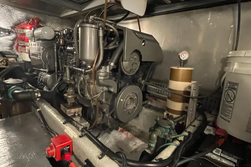 Slide: The Image of Engine room of 2003 Mainship 430 Trawler, showcasing detailed mechanical components. - 54