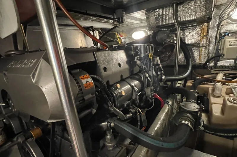 Slide: The Image of Engine room of 2003 Mainship 430 Trawler, showcasing mechanical components and wiring. - 55