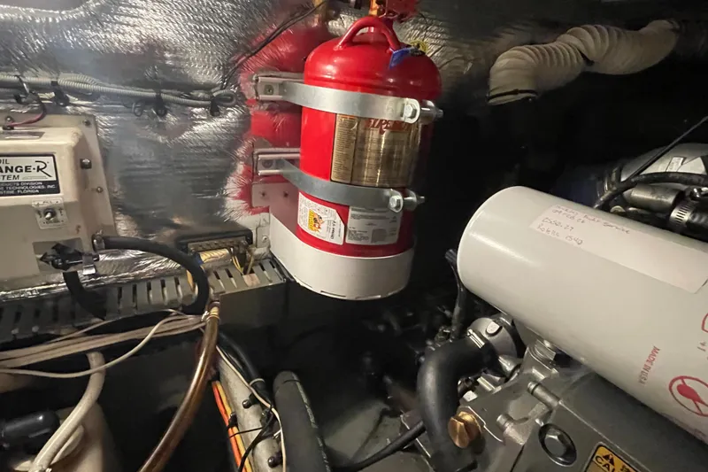 Slide: The Image of Engine room of 2003 Mainship 430 Trawler with fire extinguisher and equipment. - 57