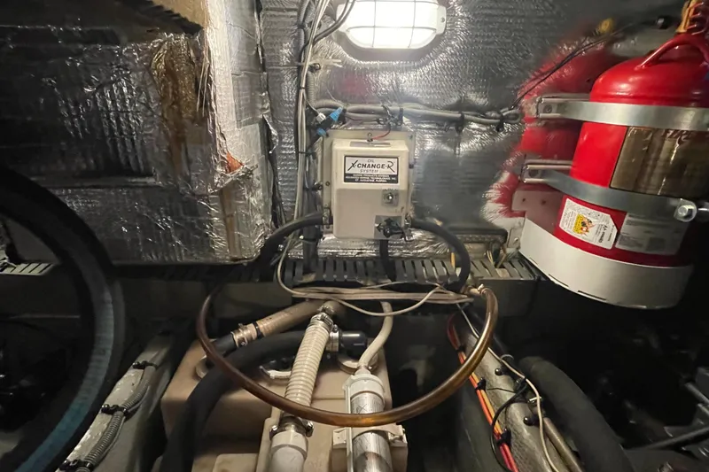 Slide: The Image of Engine room of 2003 Mainship 430 Trawler with oil change system and fire extinguisher. - 59