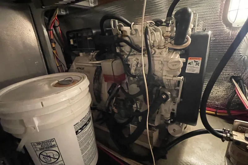 Slide: The Image of Engine room of 2003 Mainship 430 Trawler with Kohler generator and maintenance supplies. - 61