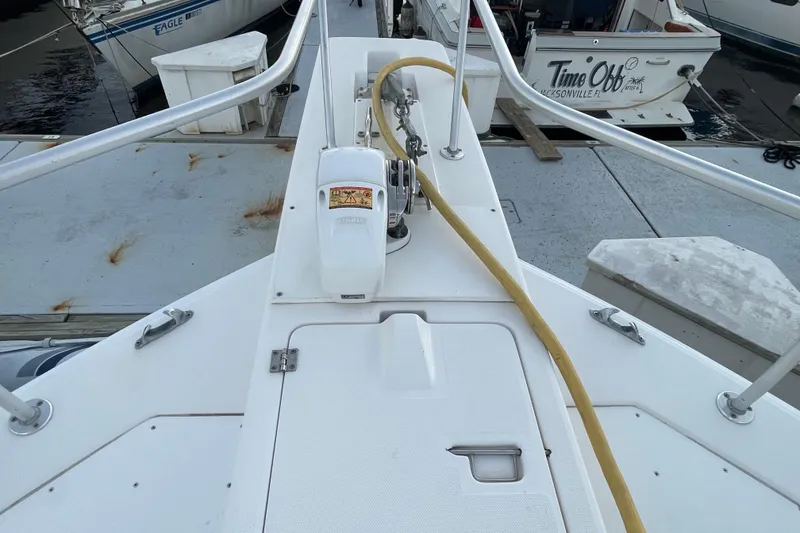 Slide: The Image of 2003 Mainship 430 Trawler deck with winch and railing at marina. - 9