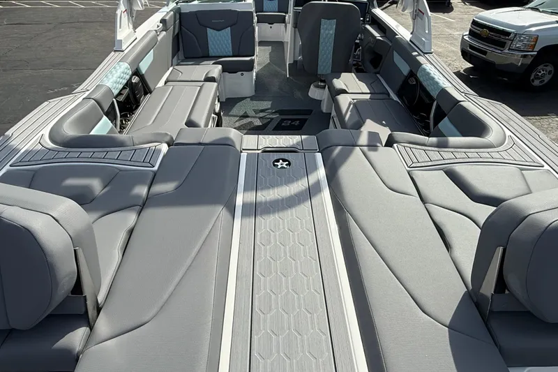 Slide: The Image of 2026 MasterCraft XT24 boat interior with luxurious gray seating and modern design. - 3