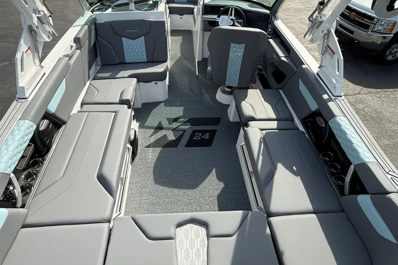Slide: The Image of 2026 MasterCraft XT24 boat interior with gray and blue seating, modern design. - 4