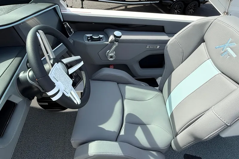 Slide: The Image of 2026 MasterCraft XT24 boat interior with steering wheel and captain's seat. - 5
