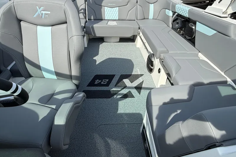 Slide: The Image of Interior of 2026 MasterCraft XT24 boat with gray and blue seating. - 7