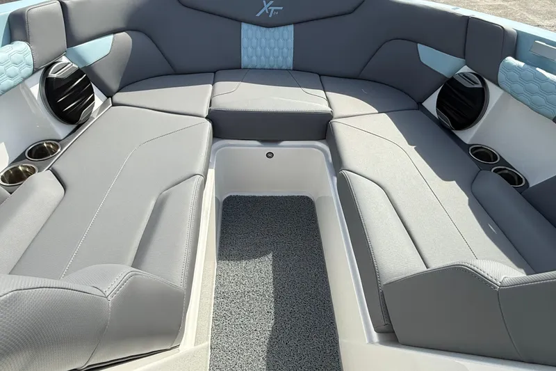 Slide: The Image of 2026 MasterCraft XT24 boat interior with gray seating and cup holders. - 8