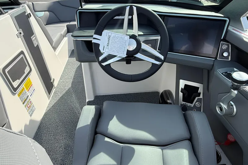 Slide: The Image of 2026 MasterCraft XT24 boat interior with modern steering wheel and dashboard controls. - 9