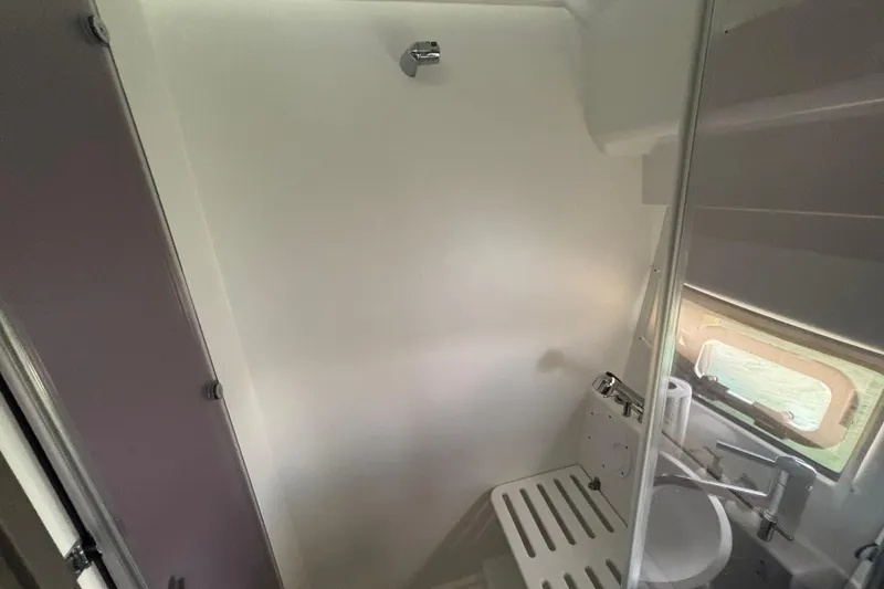 Slide: The Image of 2024 Jeanneau NC Weekender 1095 Fly bathroom with modern fixtures and window. - 19