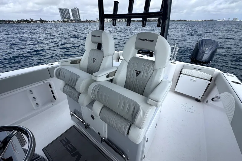 Slide: The Image of 2026 Twin Vee 280 GFX2 CC boat interior with luxury seating on open water. - 12