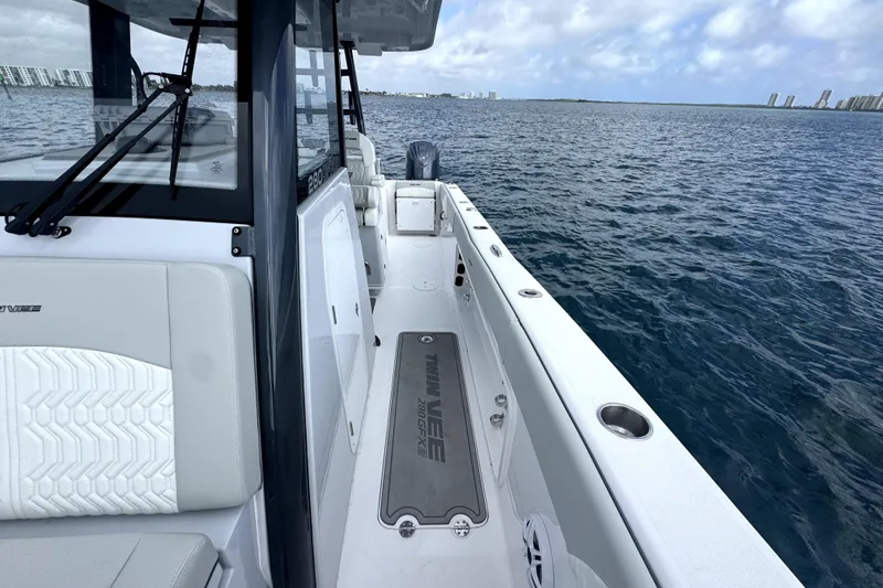Slide: The Image of 2026 Twin Vee 280 GFX2 CC boat on open water, showcasing sleek design and spacious deck. - 13