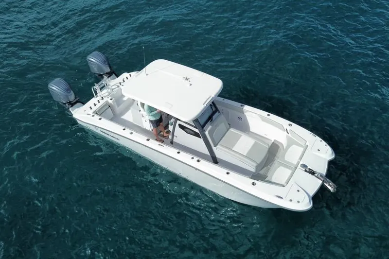 Slide: The Image of 2026 Twin Vee 280 GFX2 CC boat on clear blue water, aerial view. - 2