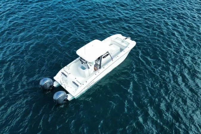 Slide: The Image of 2026 Twin Vee 280 GFX2 CC boat on open water, aerial view. - 4