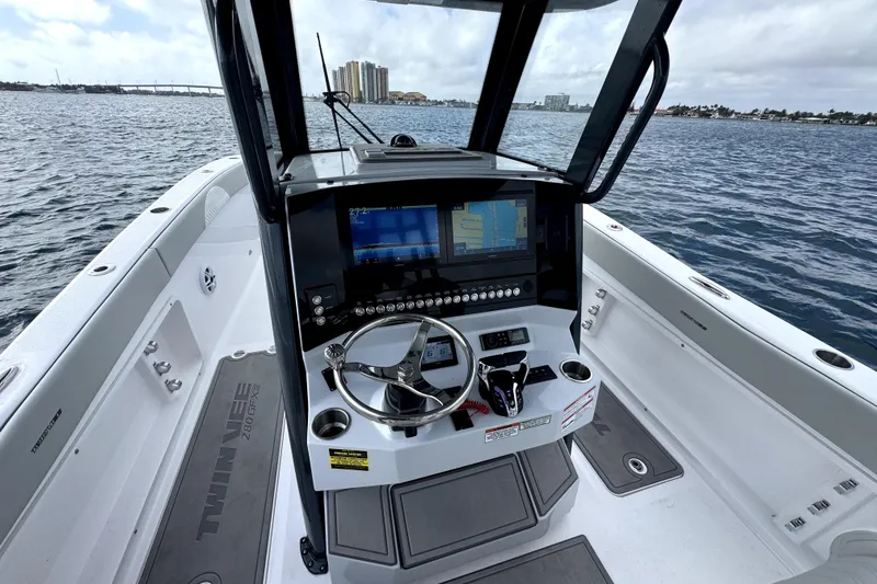 Slide: The Image of 2026 Twin Vee 280 GFX2 CC boat cockpit with modern navigation system on open water. - 8