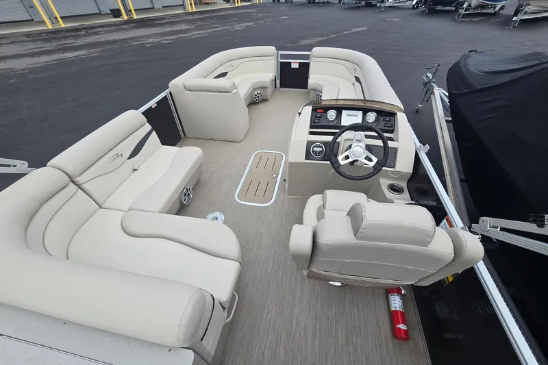 Slide: The Image of 2018 Bennington 22SSX pontoon boat interior with beige seating and steering console. - 4