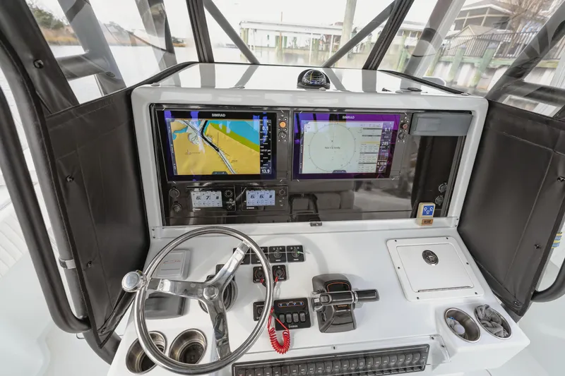 Slide: The Image of 2018 Freeman 37 VH boat dashboard with navigation screens and steering wheel. - 19