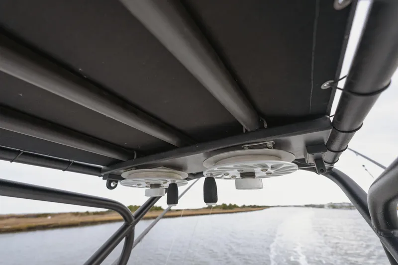 Slide: The Image of T-top view of 2018 Freeman 37 VH boat with rod holders on a waterway. - 9