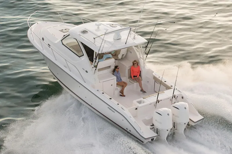 Slide: The Image of Manufacturer Provided Image: 2016 Pursuit OS 355 Offshore boat cruising on water with passengers. - 2