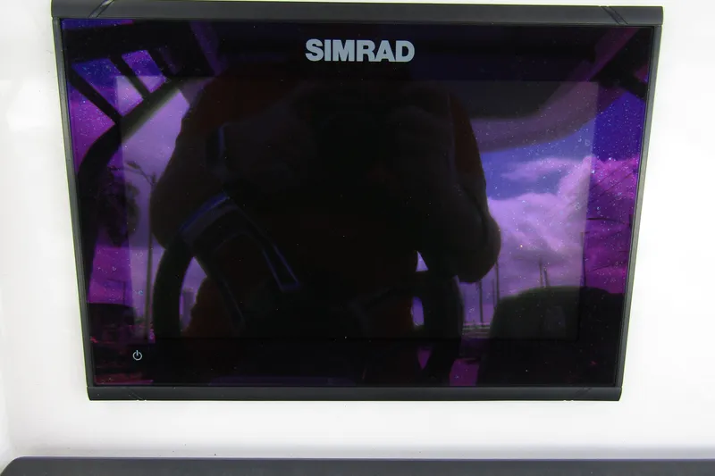 Slide: The Image of Simrad display on 2022 Axopar 22 T-Top boat, reflecting sky and surroundings. - 14