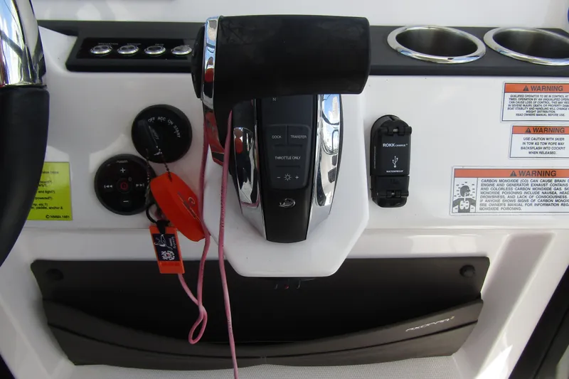 Slide: The Image of Control panel of 2022 Axopar 22 T-Top boat with throttle and warning labels. - 15