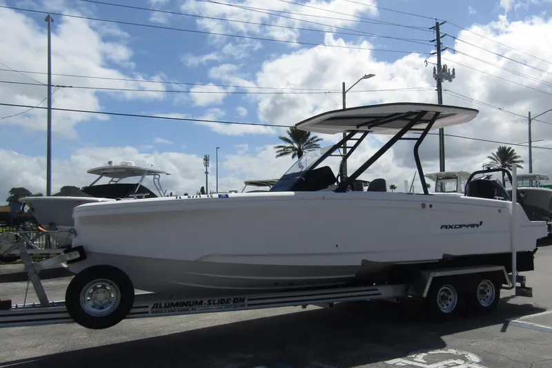 Slide: The Image of 2022 Axopar 22 T-Top boat on trailer under cloudy sky. - 5