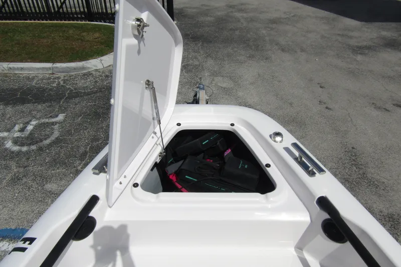 Slide: The Image of Open storage compartment on 2022 Axopar 22 T-Top boat, showing interior space. - 7