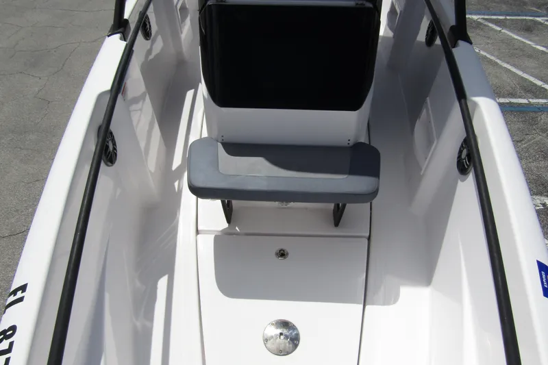 Slide: The Image of 2022 Axopar 22 T-Top boat interior with seating and storage. - 8